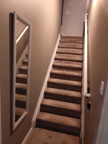 a staircase in a house with a mirror at Kings Bay Private Room Shared Bathroom D in Decatur