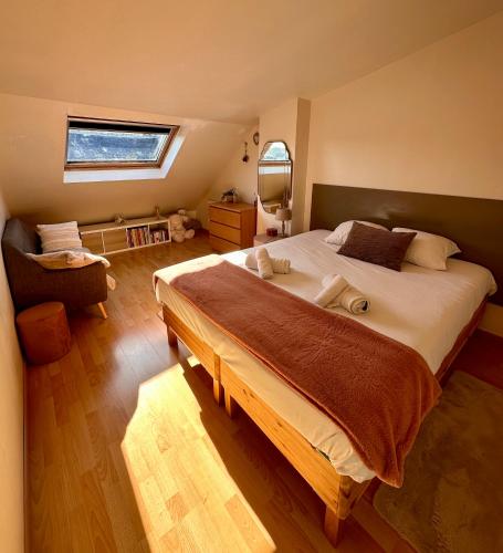 a bedroom with a large bed and a window at Le Champlain Duplex Port de plaisance in Dieppe