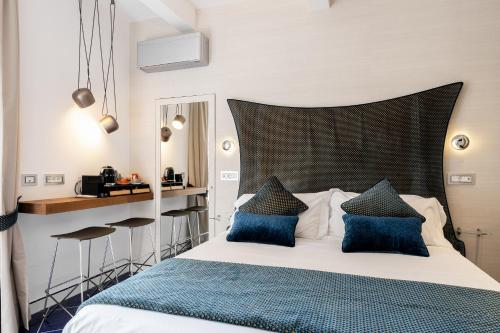 a bedroom with a large bed with blue pillows at La Suite Del Cavaliere in Amalfi