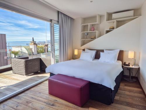 a bedroom with a large bed and a balcony at La Rouvenaz in Montreux