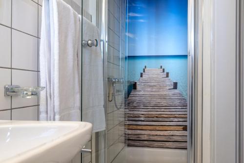a bathroom with a shower with a wooden stairway at Hotel Altstadt in Erlach