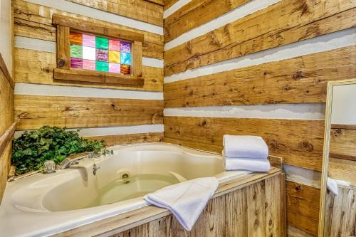 a bathroom with a tub and a sink at Pipers Place in Townsend