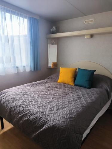 a bed with three pillows on it in a bedroom at La Dolce 1 in Lido di Dante