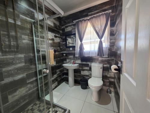 a bathroom with a toilet and a sink at Little Sister's in Colchester
