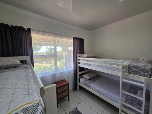 a bedroom with two bunk beds and a window at Little Sister's in Colchester