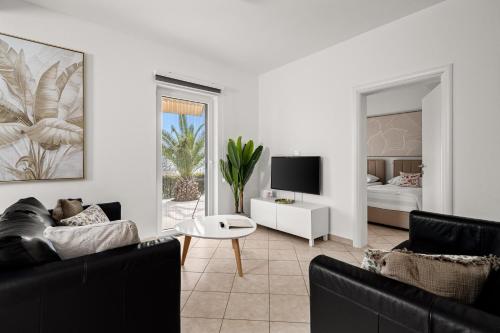 a living room with a couch and a tv at Apartment Paradiso - Ravni in Labin