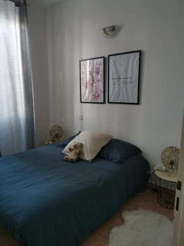 a teddy bear laying on a bed in a bedroom at Appartement T2 centre-ville in Corte