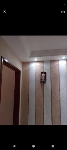 a room with brown and white striped walls and a door at POUSADA GRACAS in Cachoeira Paulista
