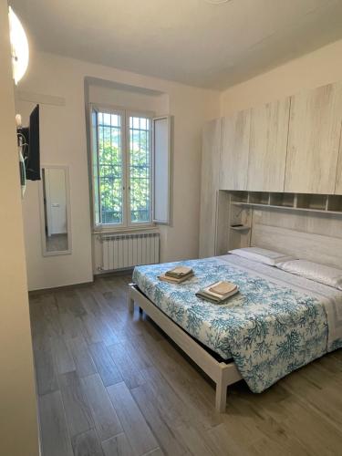 a bedroom with a bed with two books on it at Alba & Tramonto in Levanto