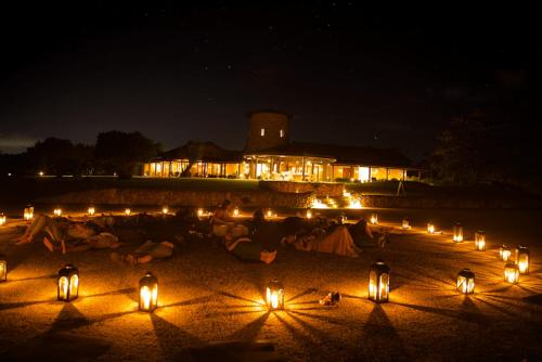 a group of people sitting on the beach at night at Royal Isabela in Isabela