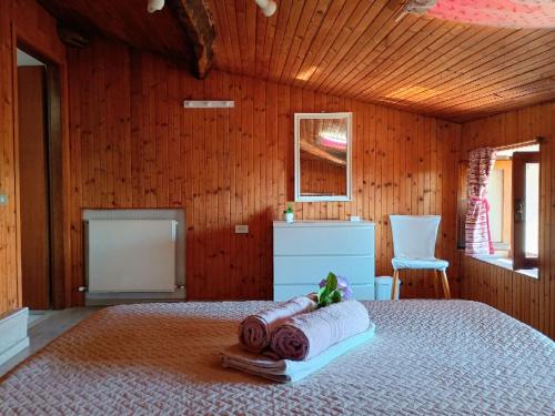 a bedroom with a bed in a wooden room at Affascinante Mansarda nel Cuore di Brunate in Brunate