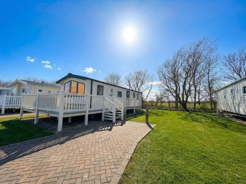 a home with a large yard with a house at Prime lakeside caravan at Haven Golden Sands in Mablethorpe
