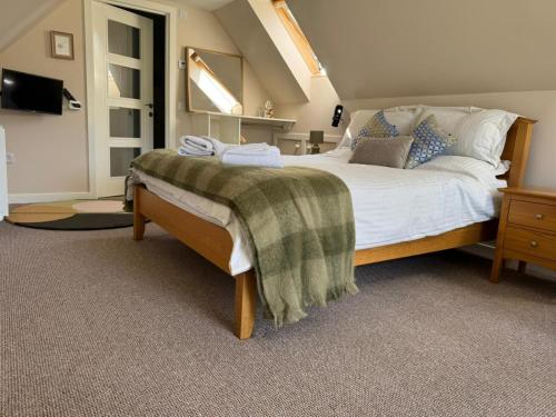 a bedroom with a large bed in a room at Westmains Lodge in Callander