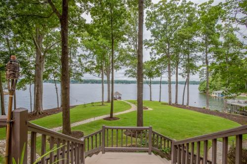 a deck with a view of the water from a house at Wake N Lake in Littleton