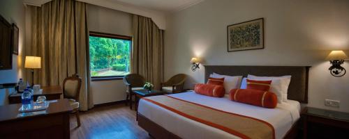 a hotel room with a large bed and a window at Clarks Khajuraho in Khajurāho