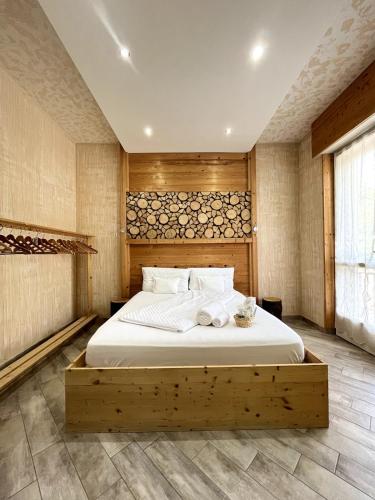 a bedroom with a large bed with a wooden headboard at Padova in Cedro in Padova