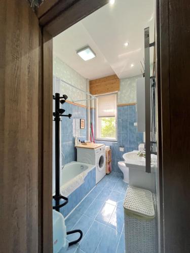 a blue bathroom with a tub and a sink at Padova in Cedro in Padova