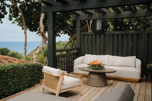 a patio with a white couch and a table at Royal Isabela in Isabela
