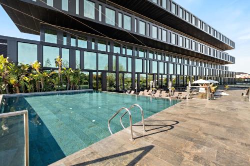 a swimming pool in front of a building at Axis Viana Business & SPA Hotel in Viana do Castelo