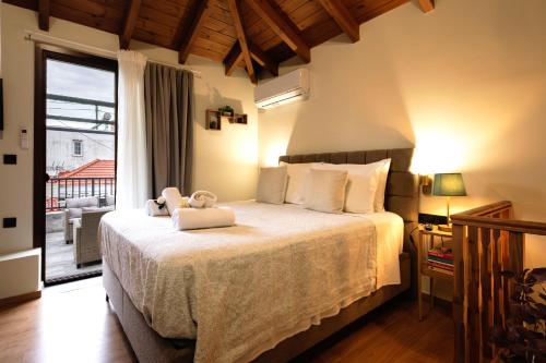 a bedroom with a bed with two teddy bears on it at Hidden Petra Luxury Suites 2 in Ialysos