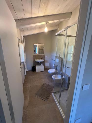 a bathroom with two toilets and a walk in shower at IL COLLE rooms in Lucca