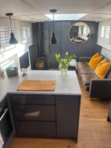 a living room with a table and a couch at Unique 2 Bed Waterside Retreat Pet Friendly in Upton upon Severn