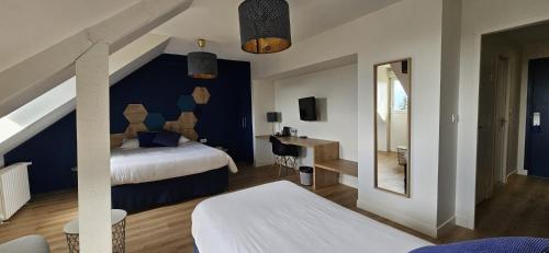 a hotel room with a bed and a mirror at Hotel le Broceliande - Sure Hotel Collection by Best Western in Bédée
