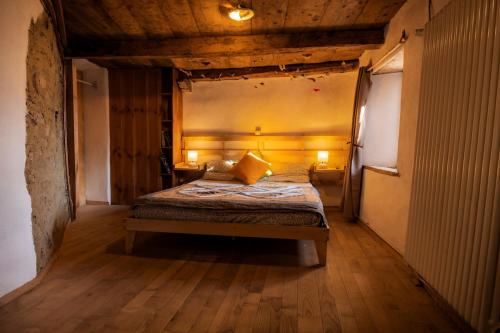 a bedroom with a bed in the middle of a room at Via del Campo 98 in Castione Andevenno