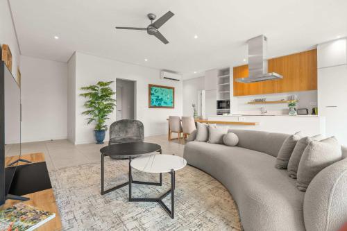 a living room with a couch and a table at Penthouse Kyo - Private Rooftop & Jacuzzi in Grand-Baie