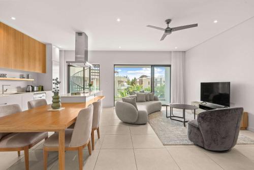 a kitchen and dining room with a table and chairs at Penthouse Kyo - Private Rooftop & Jacuzzi in Grand-Baie