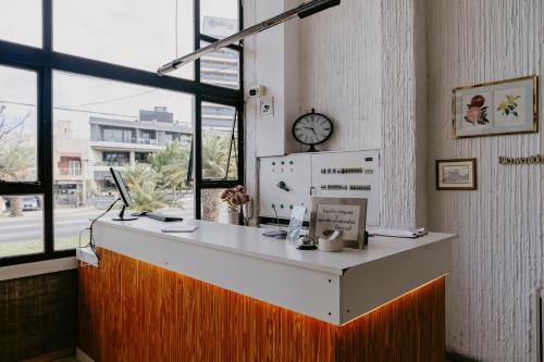 an office with a desk with a clock on the wall at Hotel Temu in Villa Carlos Paz