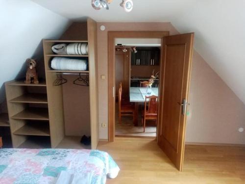 a bedroom with an open door to a room at Lastovička in Ihráč