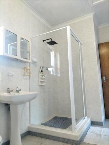 a bathroom with a shower and a sink at 15 on 11th Summerstrand in Summerstrand