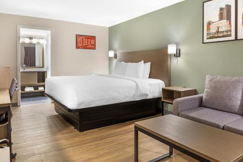 a hotel room with a bed and a couch at Quality Inn Findlay in Findlay