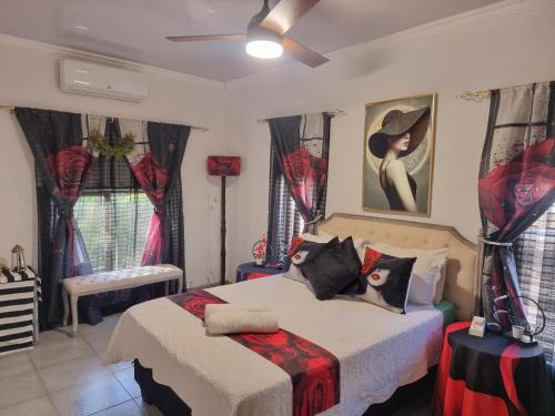a bedroom with two beds with red and black pillows at Boskraai Self-Catering -74 Hornbill Street in St Lucia