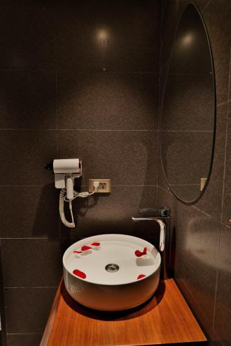a bathroom with a toilet with red hearts on it at Sapa Lumia Hotel in Sapa