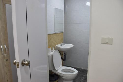 a small bathroom with a toilet and a sink at alone happy 3 in Ban Khlong Thewa