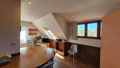 a room with a table and chairs and a window at Oostduinkerke Apartments in Oostduinkerke
