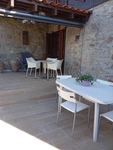 a group of tables and chairs on a patio at CASA DE MADEIRA E PEDRA in Afife
