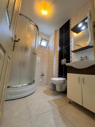 a bathroom with a shower and a toilet and a sink at Mermaid in Marmaris