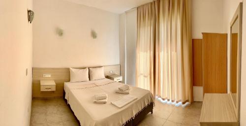a hotel room with a bed with two phones on it at Mermaid in Marmaris