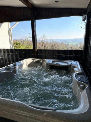a jacuzzi tub with a view of the mountains at WW Luxury Cottage in Müschenbach