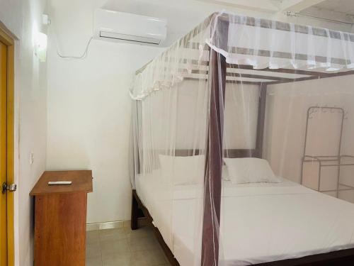 a bedroom with a bunk bed with a canopy at Thalalla BnB in Talalla South