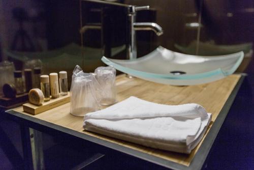 a bathroom counter with a sink and towels on it at Hôtel Du Leman in Paris