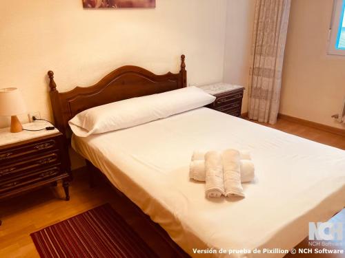 a bedroom with a bed with two towels on it at Amapola 1 in Soria
