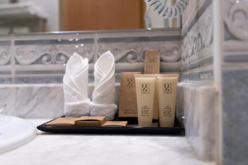 a tray with some toiletries on a counter in a bathroom at Luxe Grand Hotel in Dubai