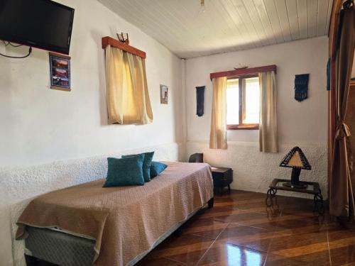 a bedroom with a bed and a window and a television at Maridalba 1 in La Coronilla