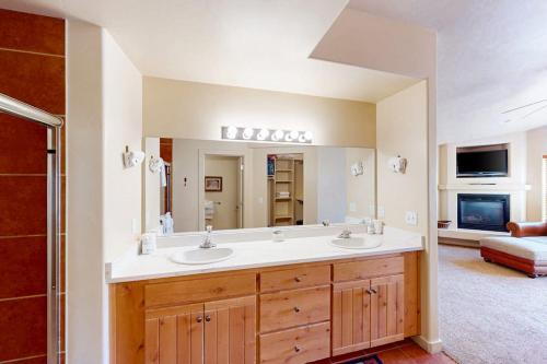 a bathroom with two sinks and a large mirror at Rim Village O3 in Moab