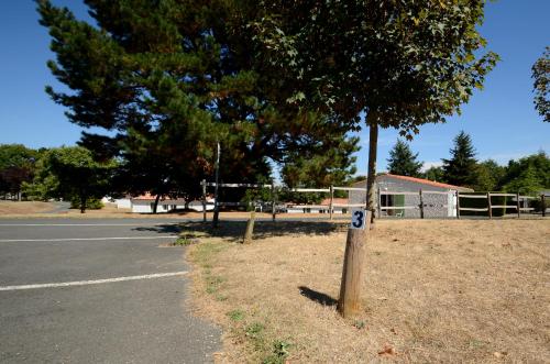 a tree with a number on it next to a street at Village Vacances de Chantonnay in Chantonnay