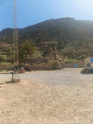 a large empty field with a mountain in the background at Diar twins in Gabès